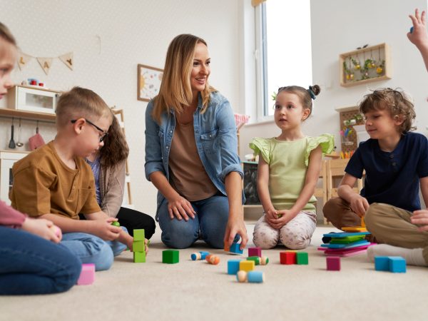 Teacher performs exercises to the children
